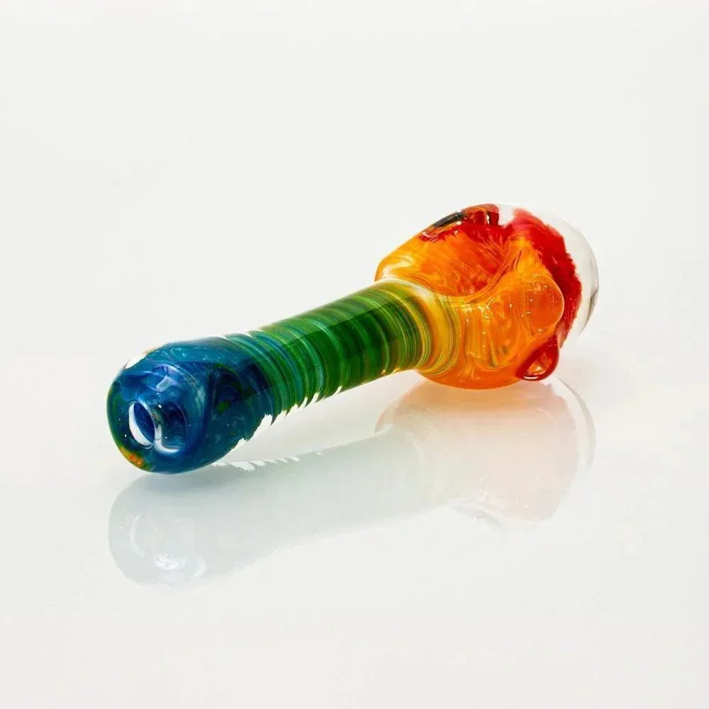 Colorful glass rainbow frit honeycomb spoon pipe on a white background