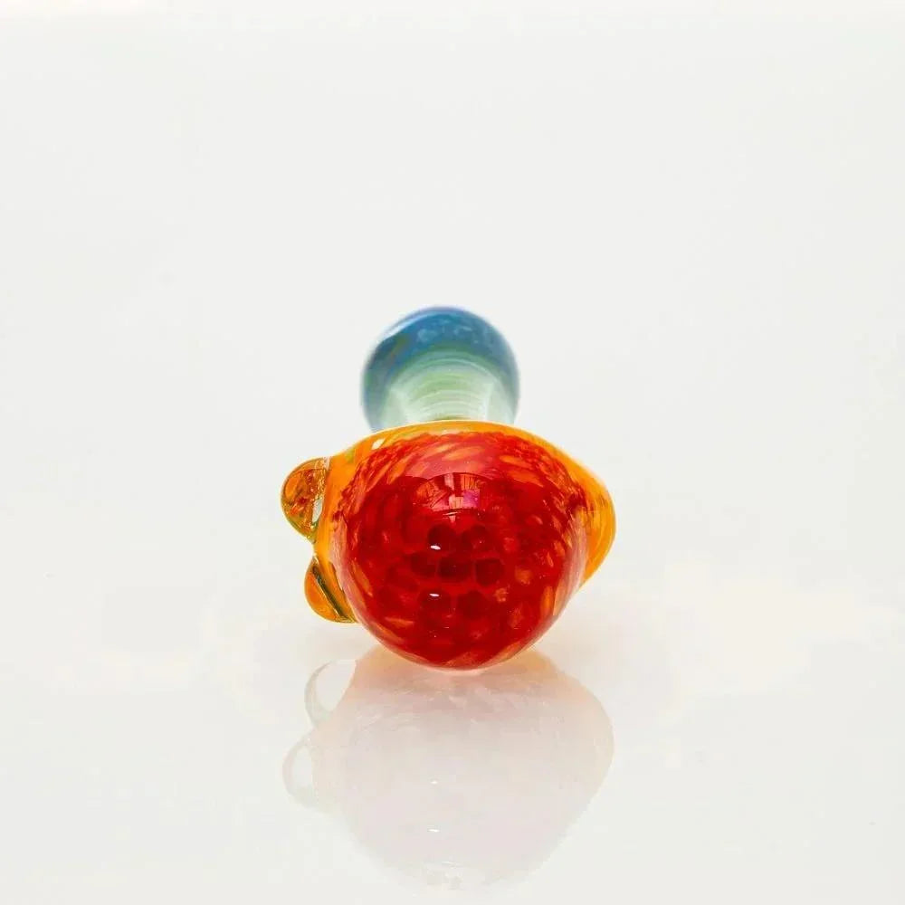 Rainbow frit glass spoon pipe with red honeycomb design on white background