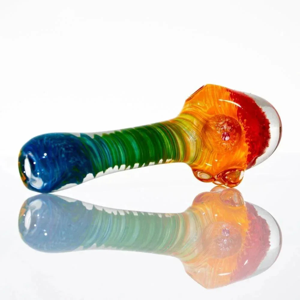 Colorful rainbow glass spoon pipe with honeycomb design, displayed on white background.