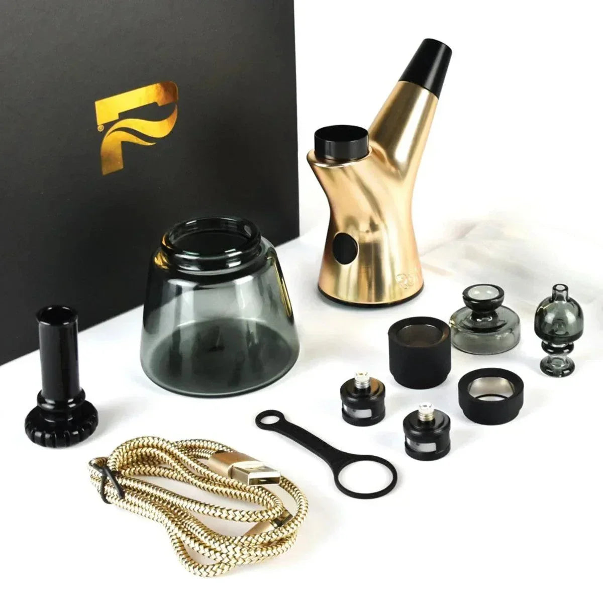 Gold and black vaporizer kit with glass attachments, USB cable, and accessories on white surface