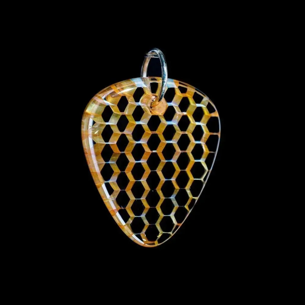 Striped glass guitar pick pendant with honeycomb pattern and metal ring on black background.