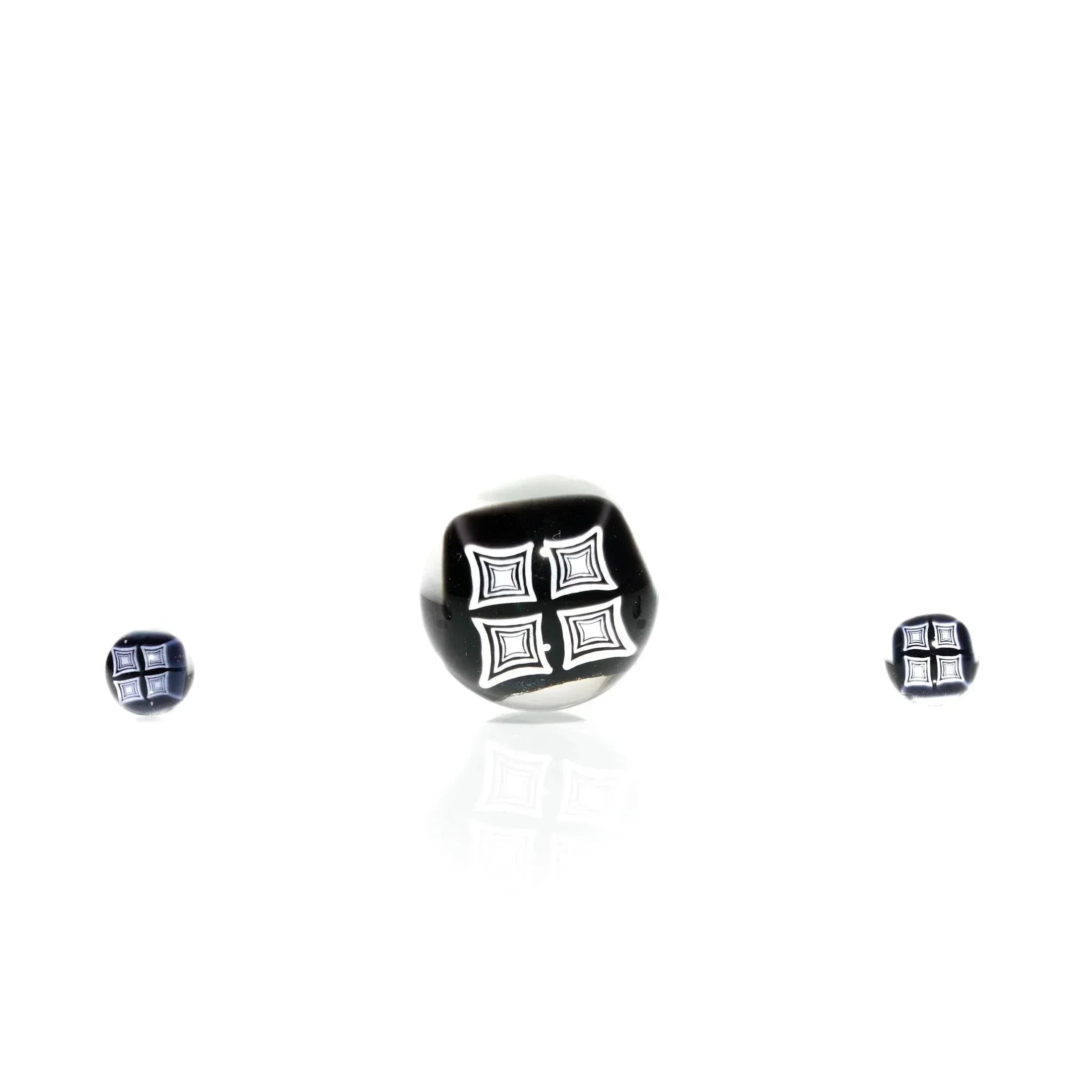 Black and white glass terp pearls and marble set with geometric designs on a white background