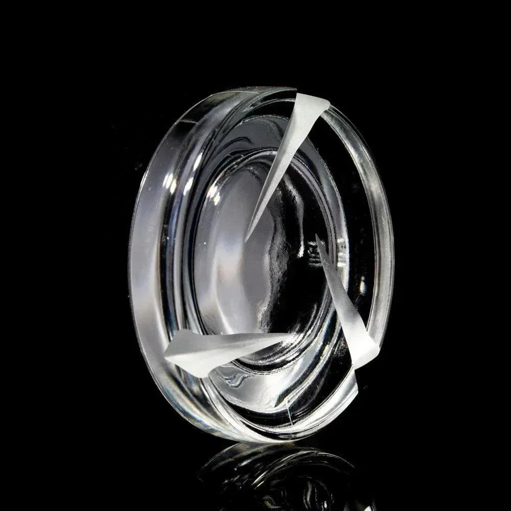 Clear 7ml glass spinner jar with unique internal fins on a black background