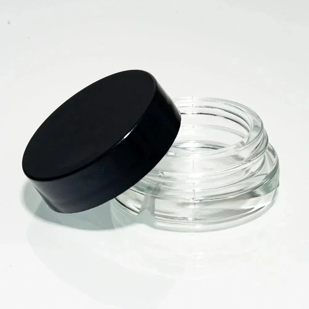 Clear glass storage jar with a black lid, ideal for concentrates or herbal accessories