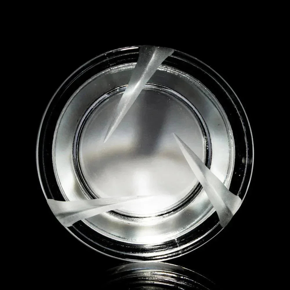 Clear glass 7ml spinner jar with angled airflow slits on black background