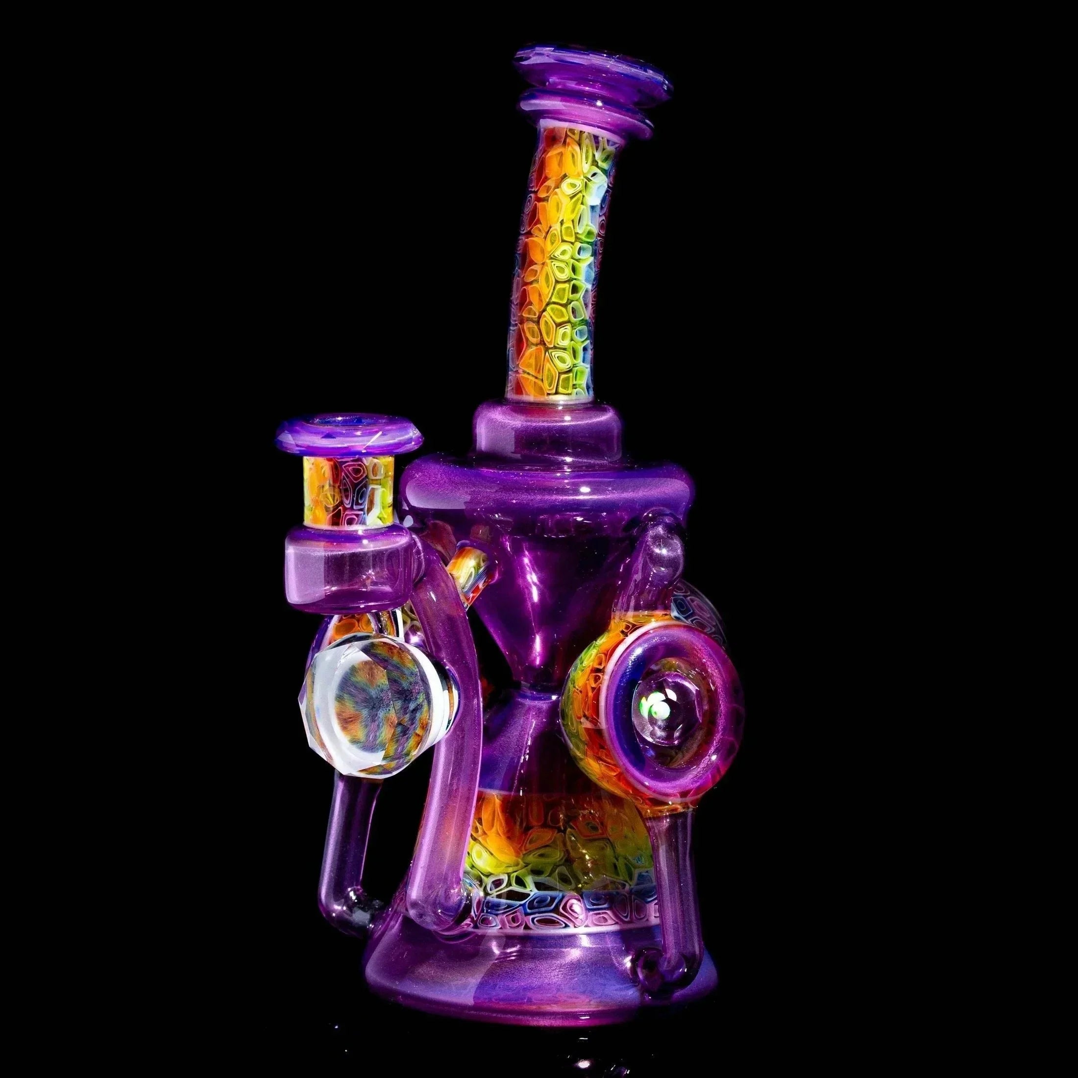 Colorful heady glass water pipe with purple hues and intricate rainbow patterns on black background