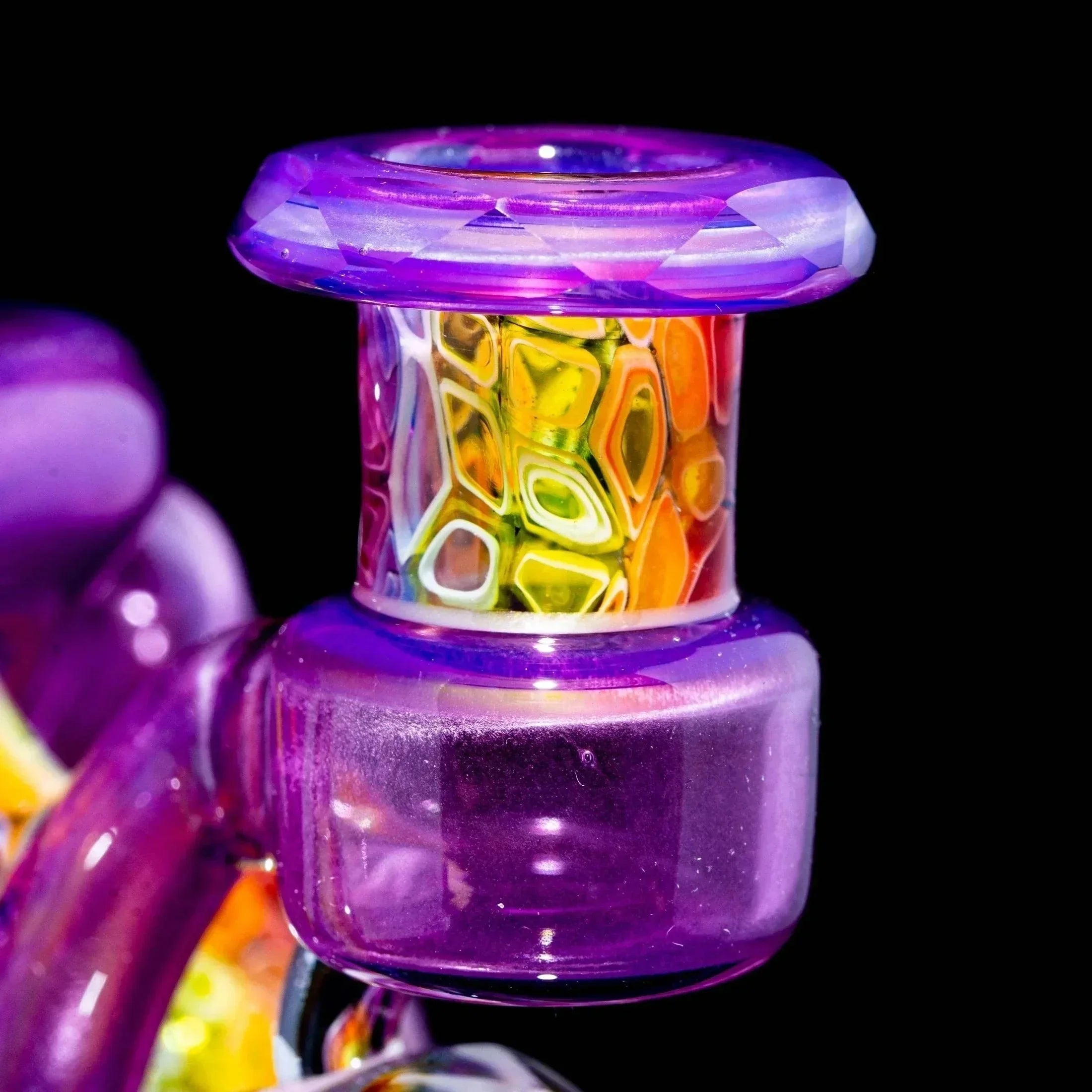 Close-up of a colorful heady glass pipe with intricate patterns and purple accents