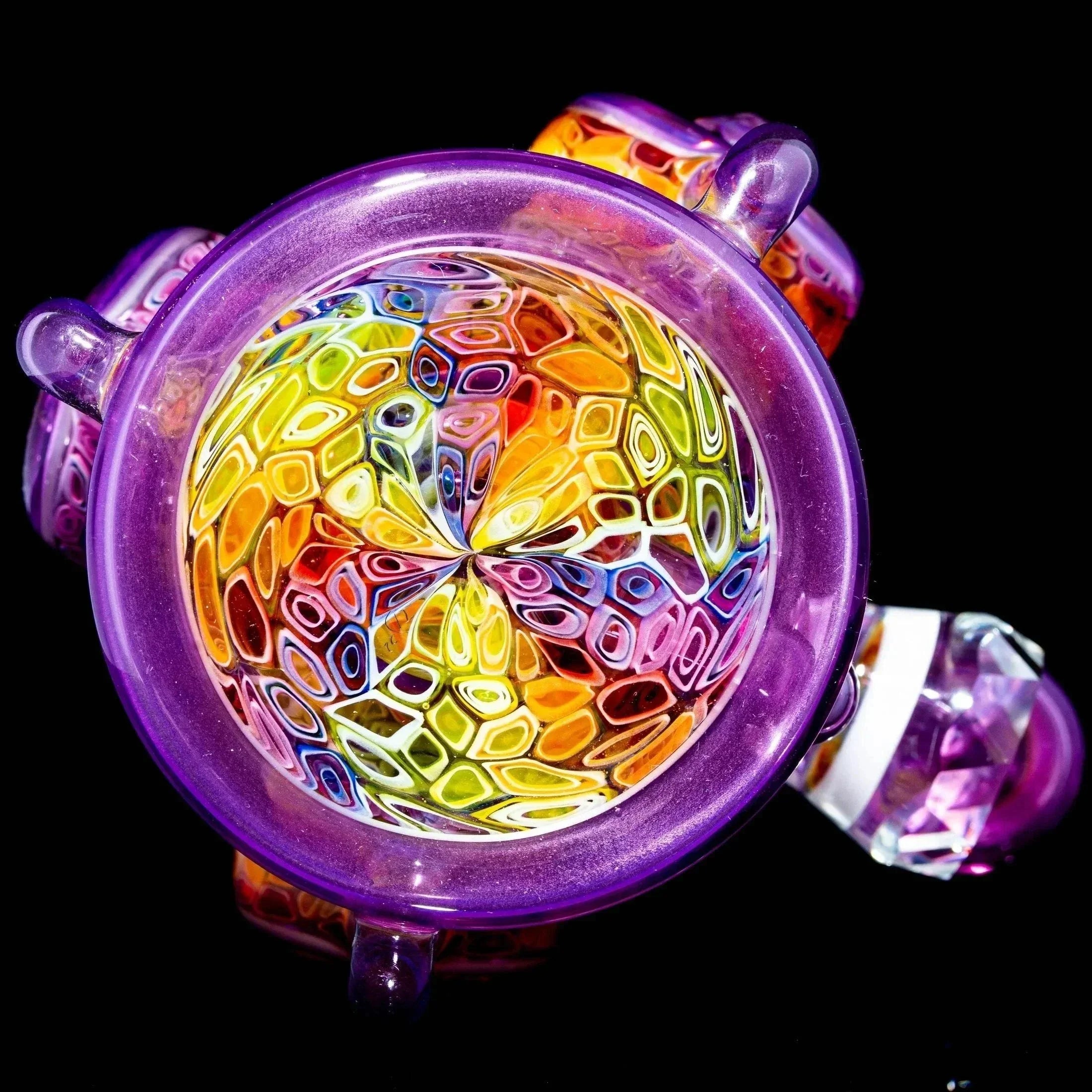 Colorful heady glass bowl with intricate rainbow pattern and purple accents on black background