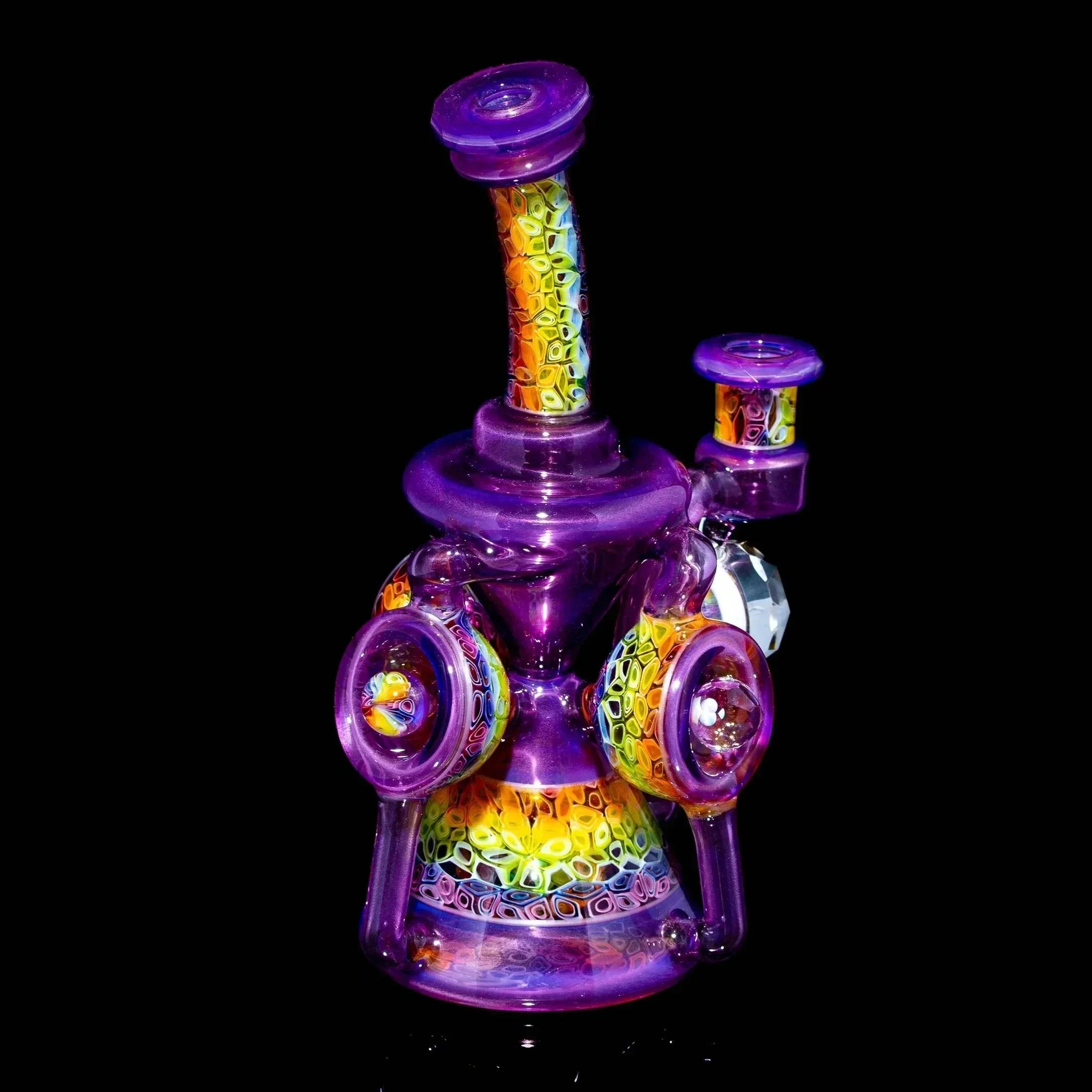 Colorful heady glass water pipe with intricate purple and rainbow pattern on black background