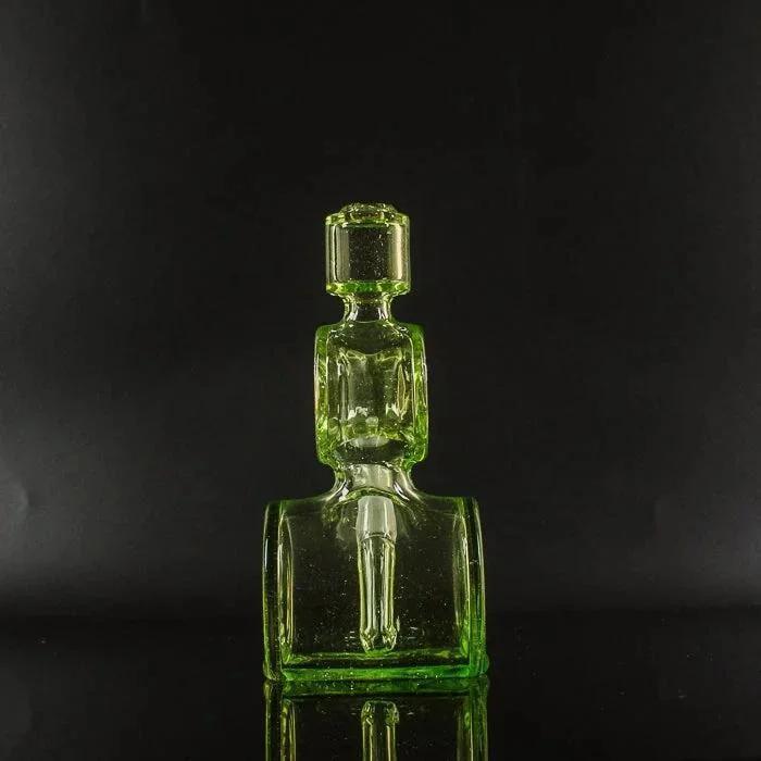 Vibrant green glass pipe with geometric design, showcasing heady glass craftsmanship against black background
