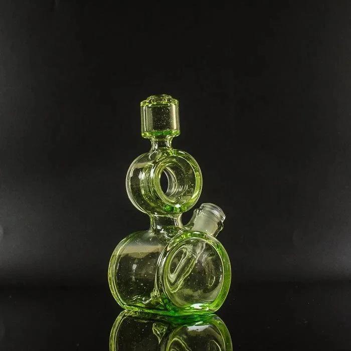 Vibrant green heady glass bubbler with stacked chambers and reflective surface