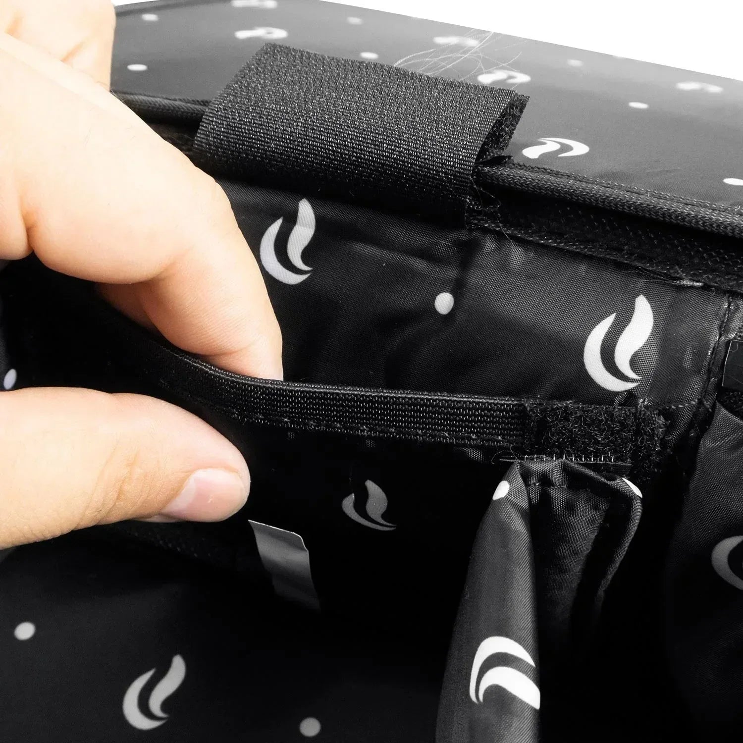 Hand opening black padded storage bag with inner pocket and white flame pattern lining