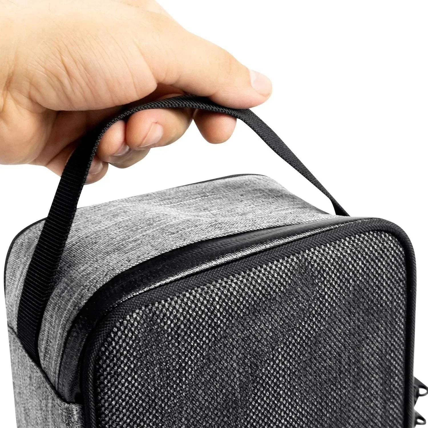 Hand holding a grey textured carrying case with a zipper and black strap
