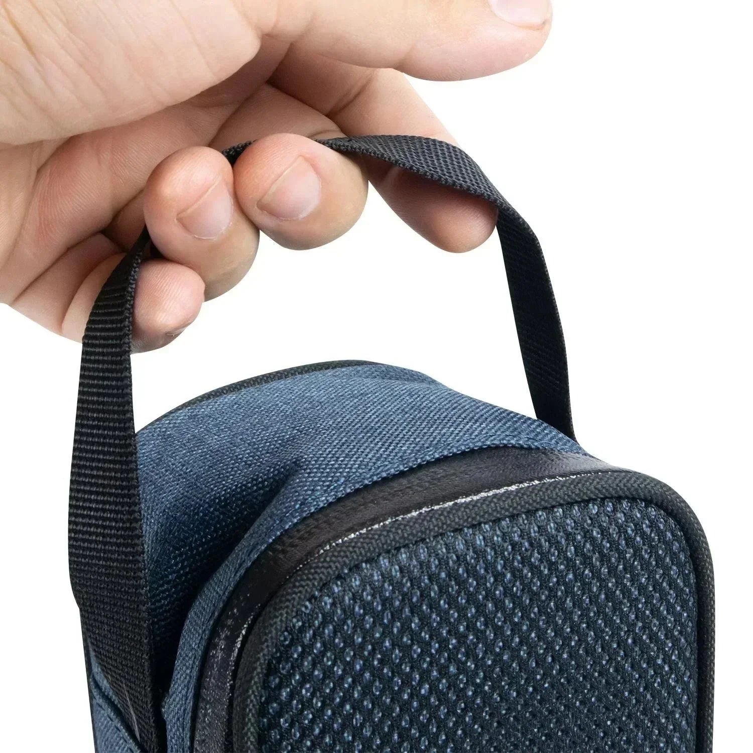Hand holding a small blue textured carrying case with a black handle