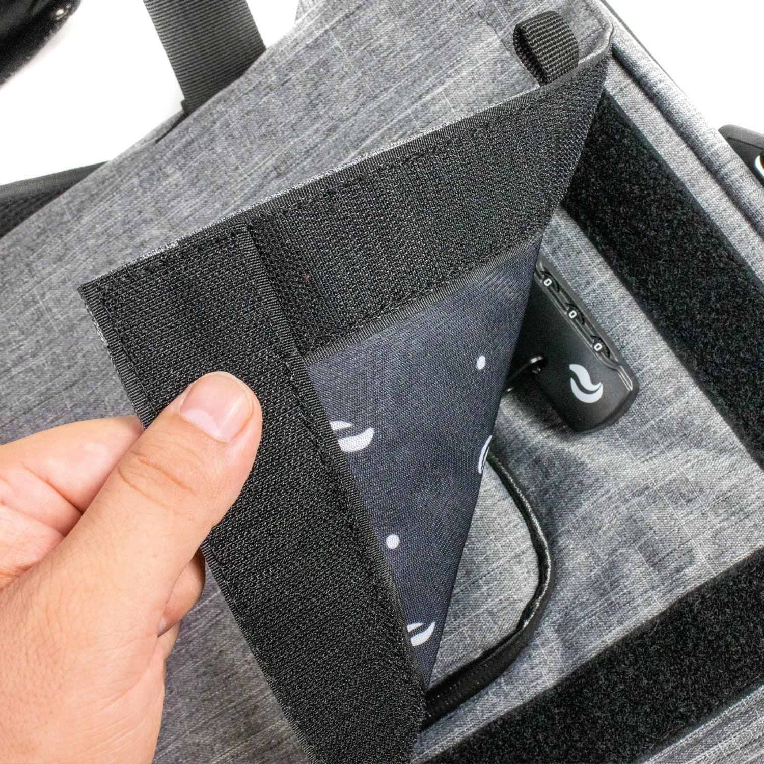Close-up of a gray hybrid smell-proof bag with locking zipper and Velcro flap