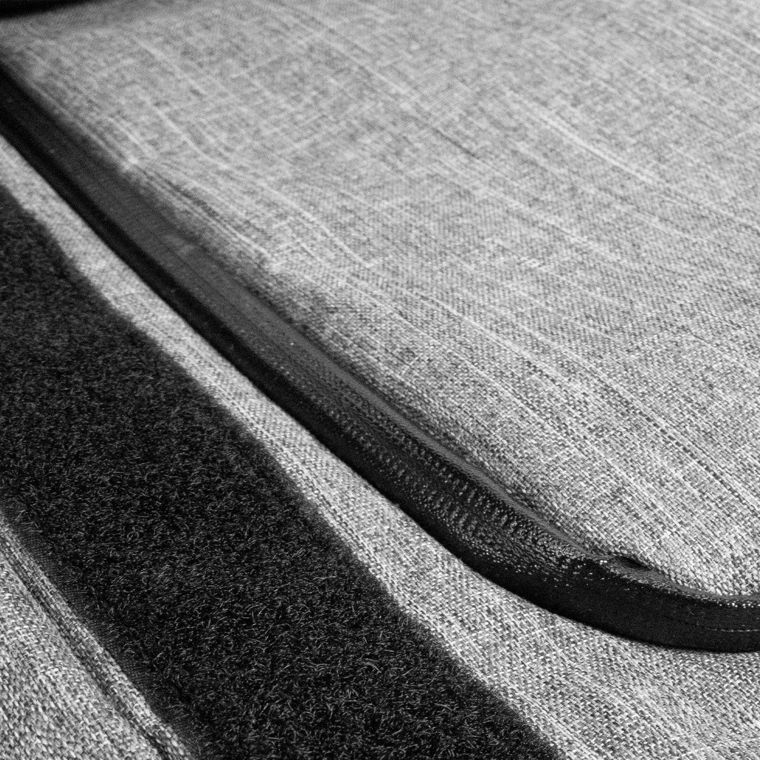 Closeup of gray fabric case with black zipper and velcro, protective storage accessory
