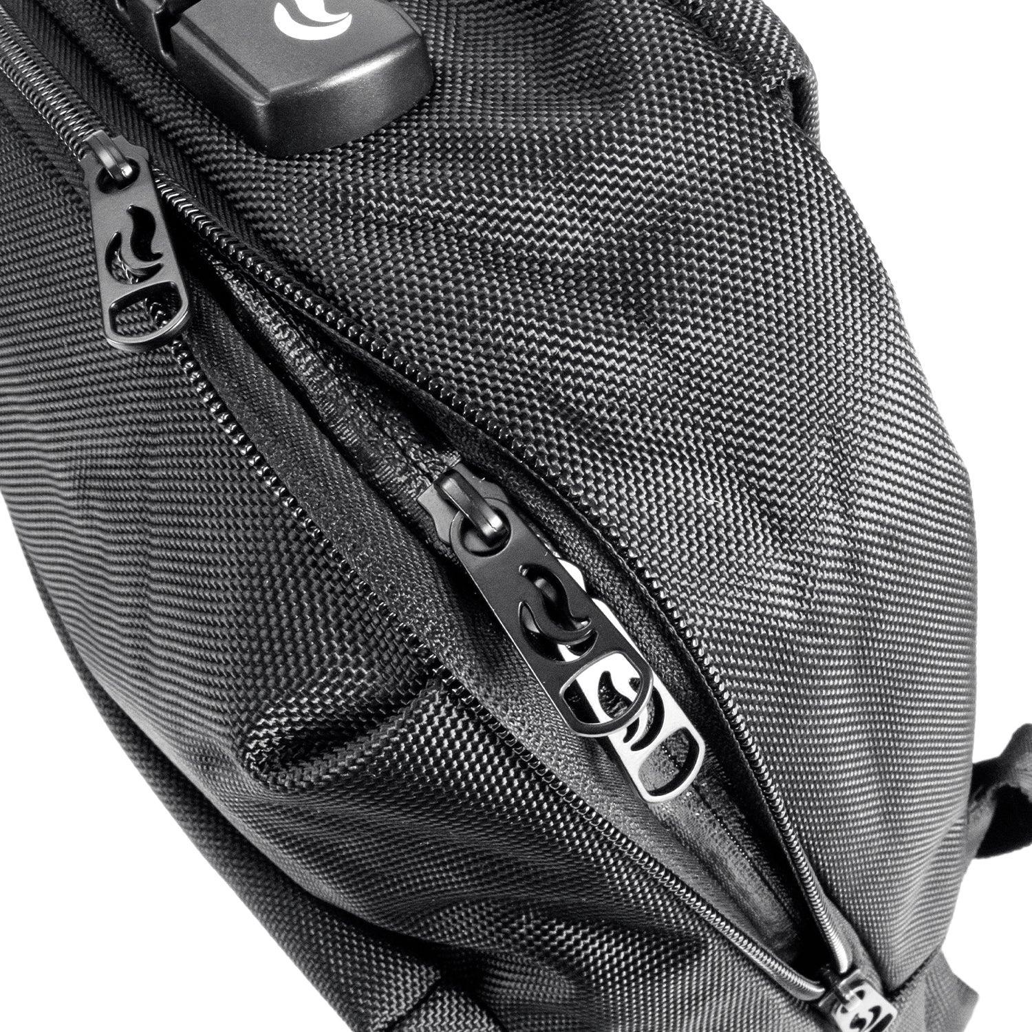 Close-up of black textured bag with double zippers and a combination lock