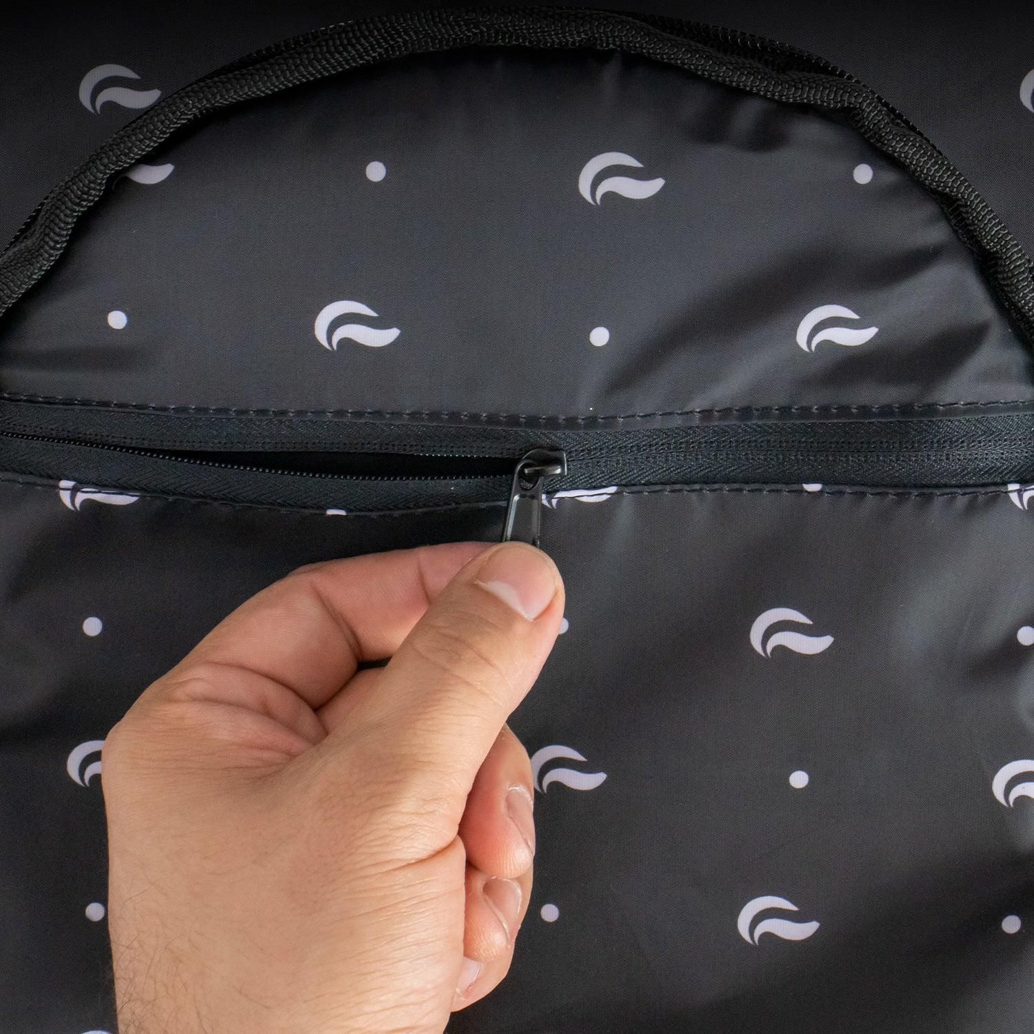 Hand opening black fabric zipper pocket with white pattern detail
