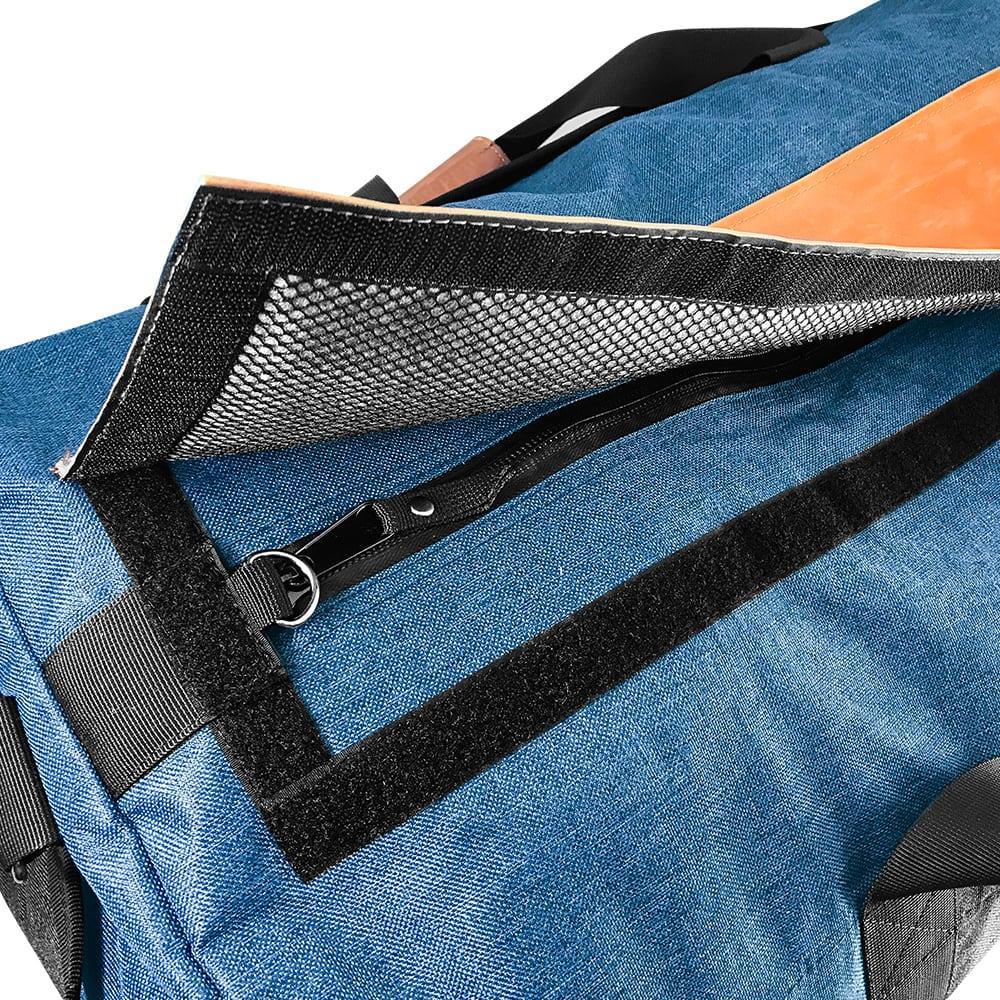 Blue smell-proof duffle bag with open velcro flap, mesh lining, and zipper pocket