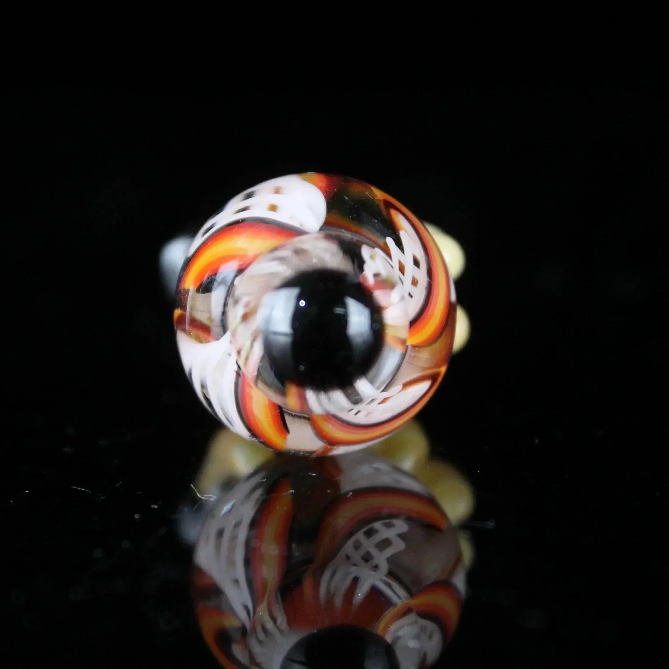 Colorful borosilicate glass terp slurper marble with orange, yellow, and white lattice design
