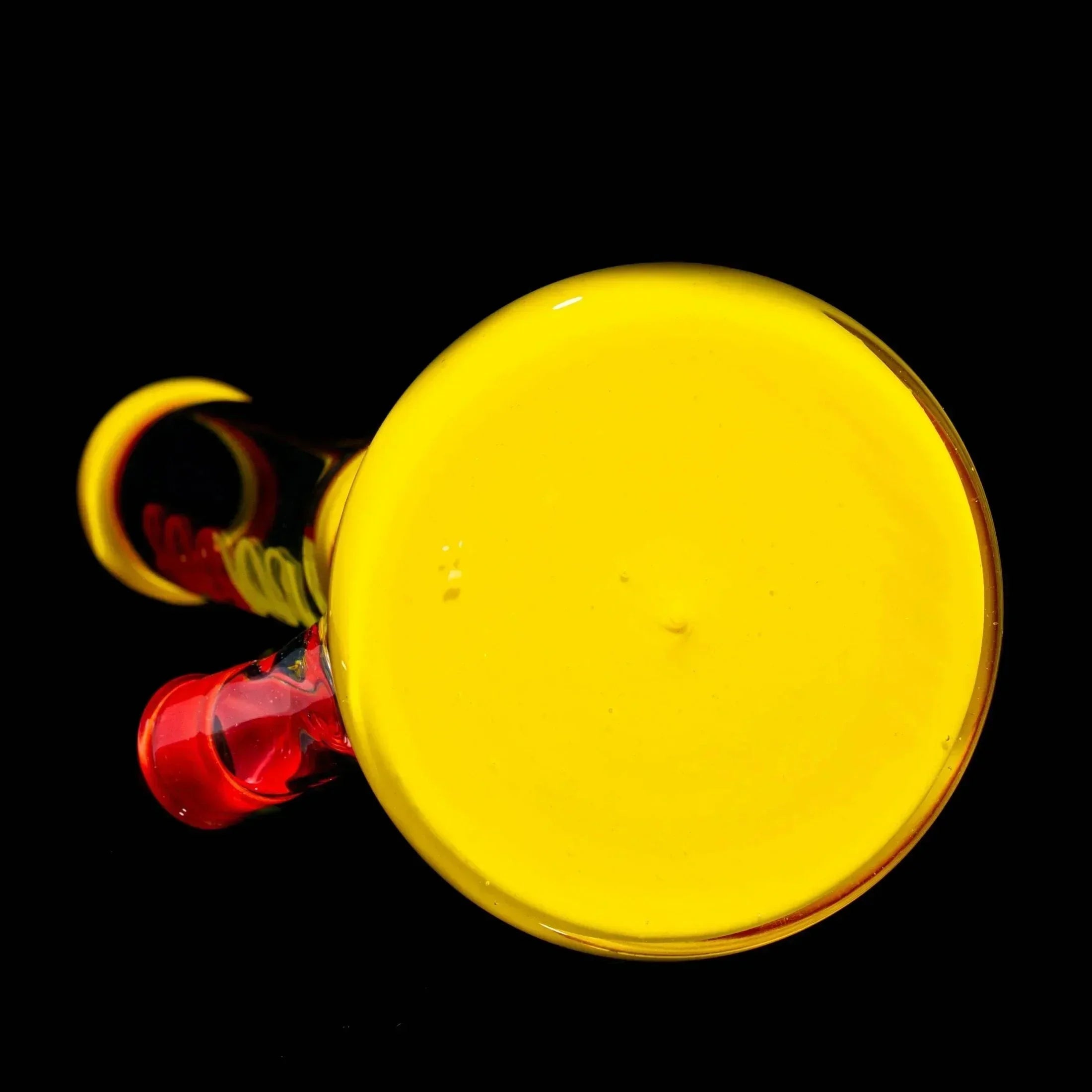 Colorful glass hand pipe with bold yellow and red accents on a black background