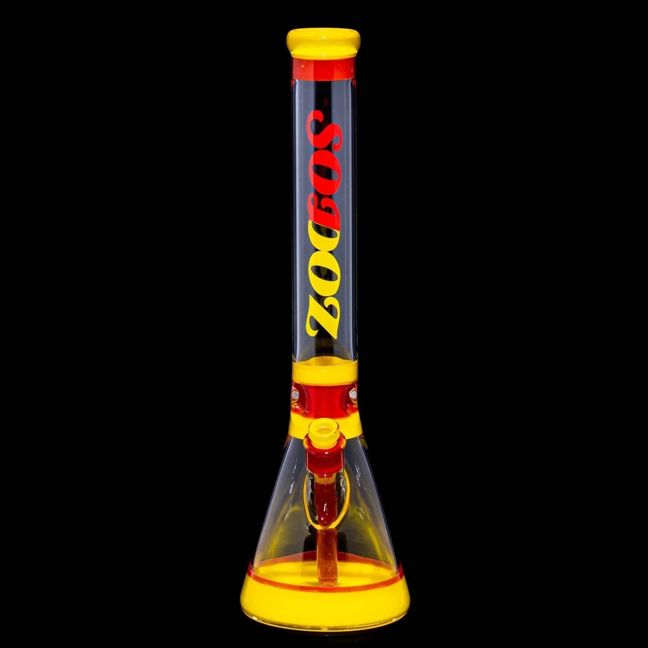 Clear and yellow glass water pipe with red accents on black background