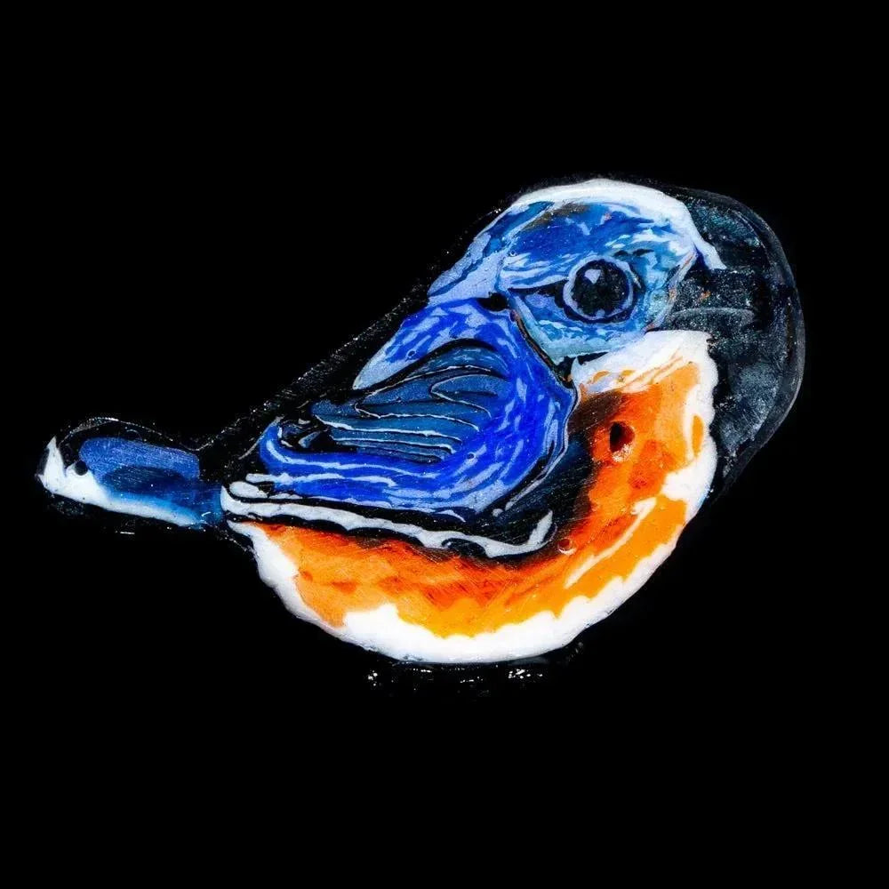 Handcrafted glass pendant shaped like a bluebird with vibrant blue and orange detailing.