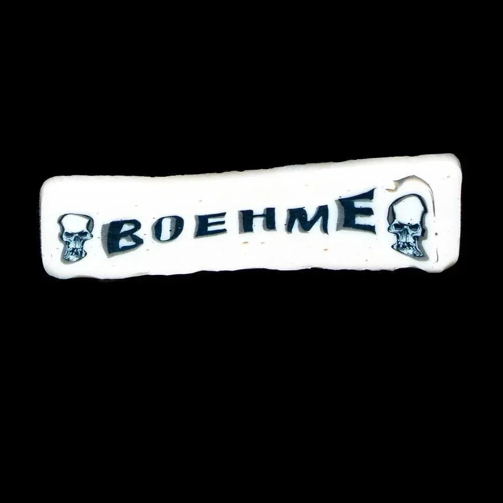 White ceramic coin with skull illustrations and BOEHME text on black background