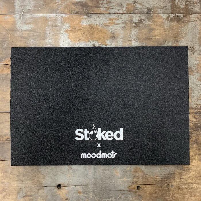 Stoked x moodmat black textured mat on rustic wood floor