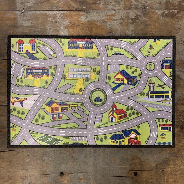 Colorful kids' road map rug with houses, roads, and airport, perfect for playrooms or nurseries.