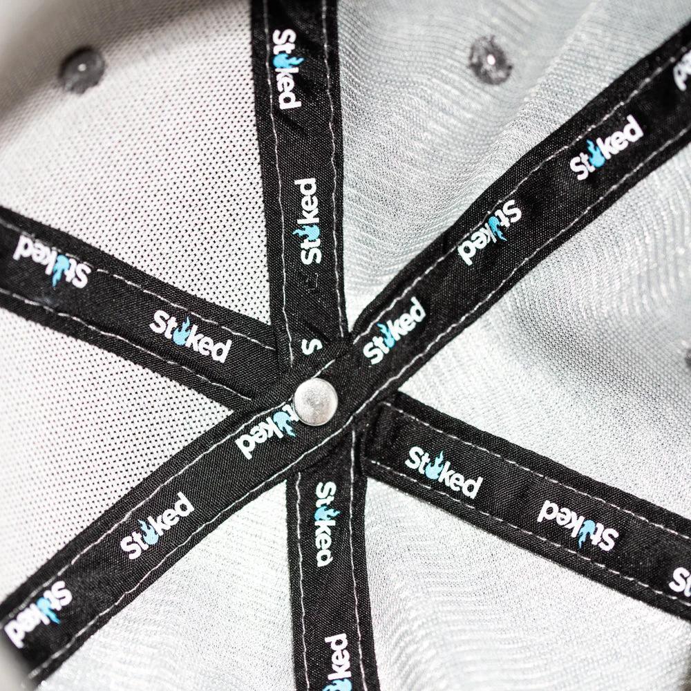 Stoked branded cap interior with repeating logo on black panels and gray mesh backing