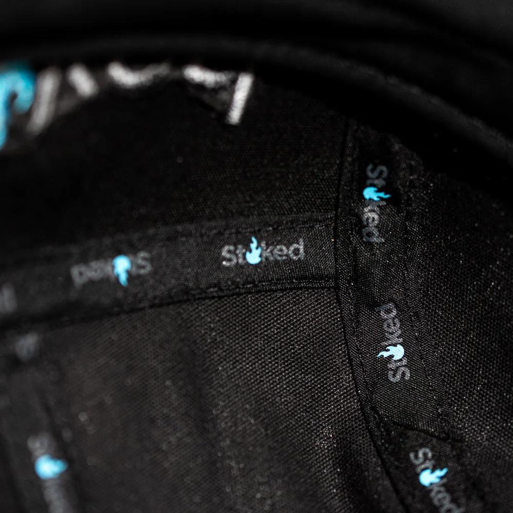 Black Stoked x PAXS cap interior with glow-in-the-dark logo tags