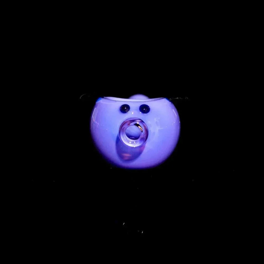 Milky purple glass piggy spoon pipe with black accents on a black background