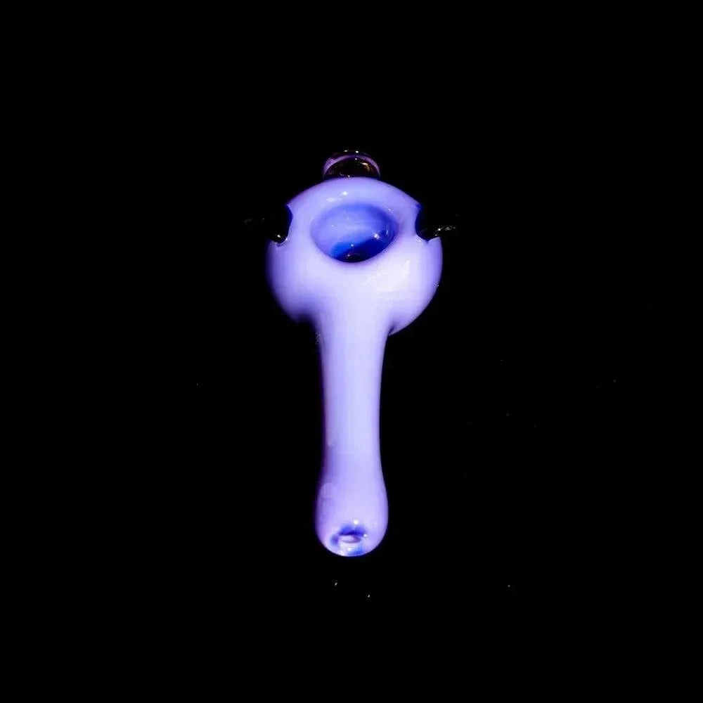 Milky purple glass hand pipe with bowl, spoon-shaped, on black background