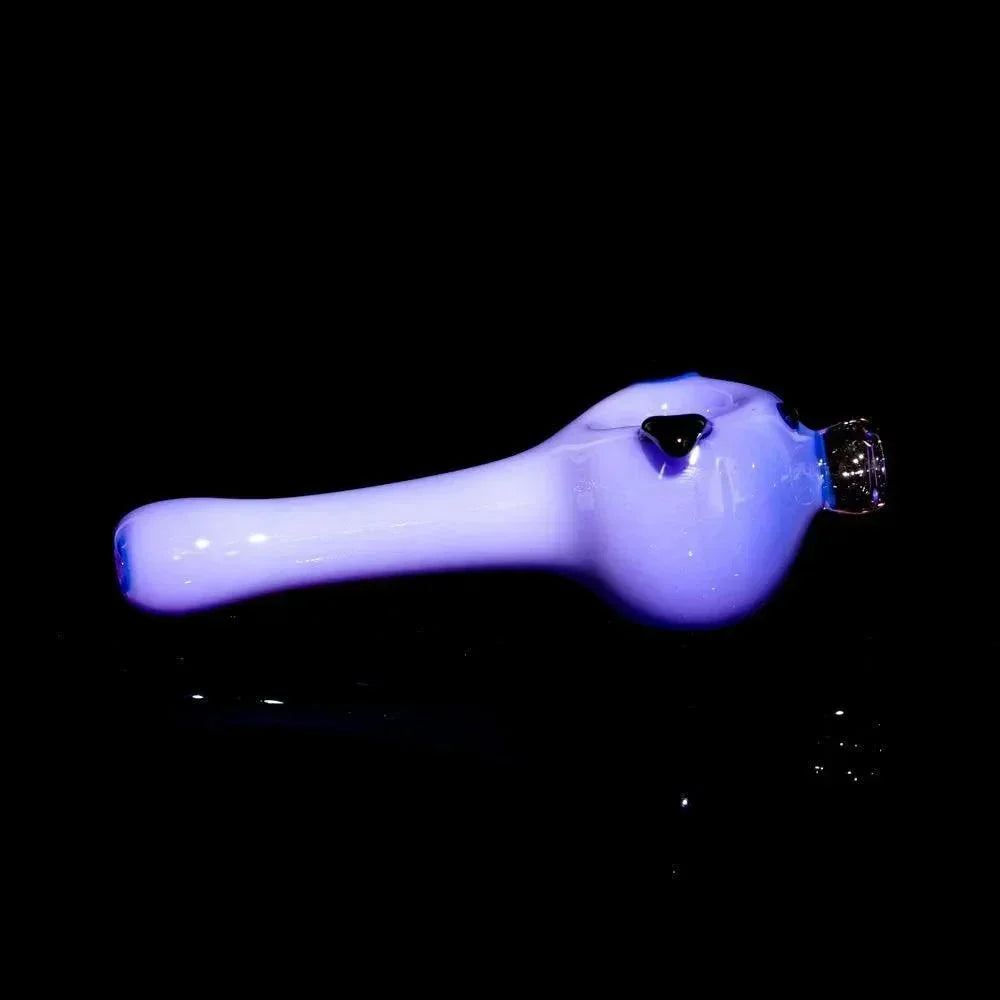 Milky purple glass spoon pipe shaped like a piggy, with black accents on a black background