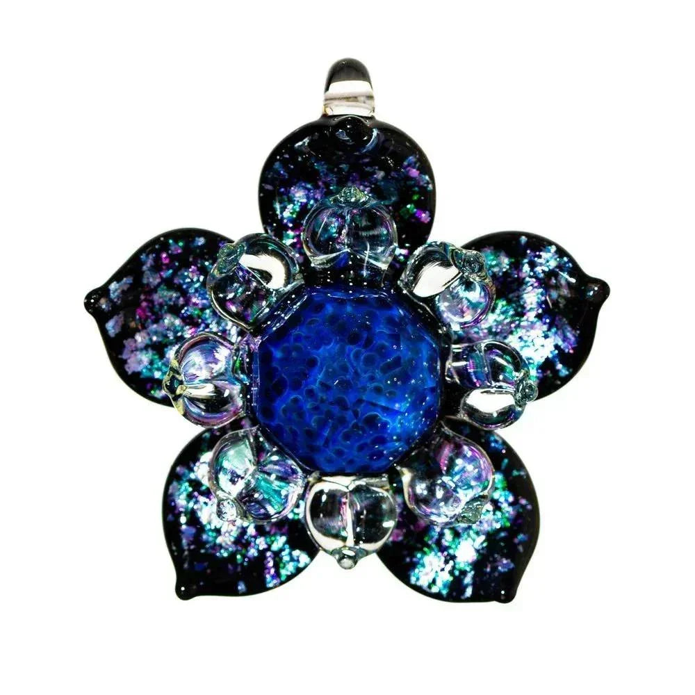 Faceted glass flower pendant with blue center and iridescent petals on white background