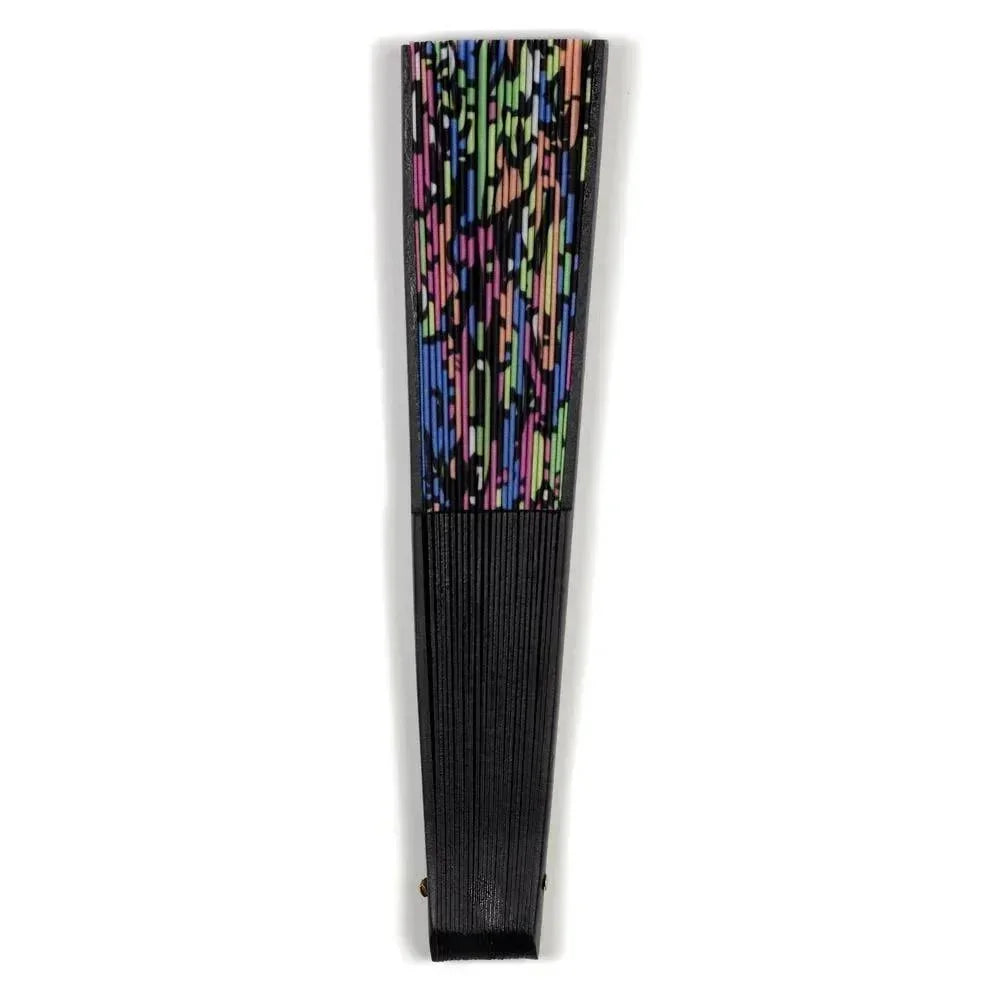 Folded black hand fan with colorful abstract pattern on top section, isolated on white.