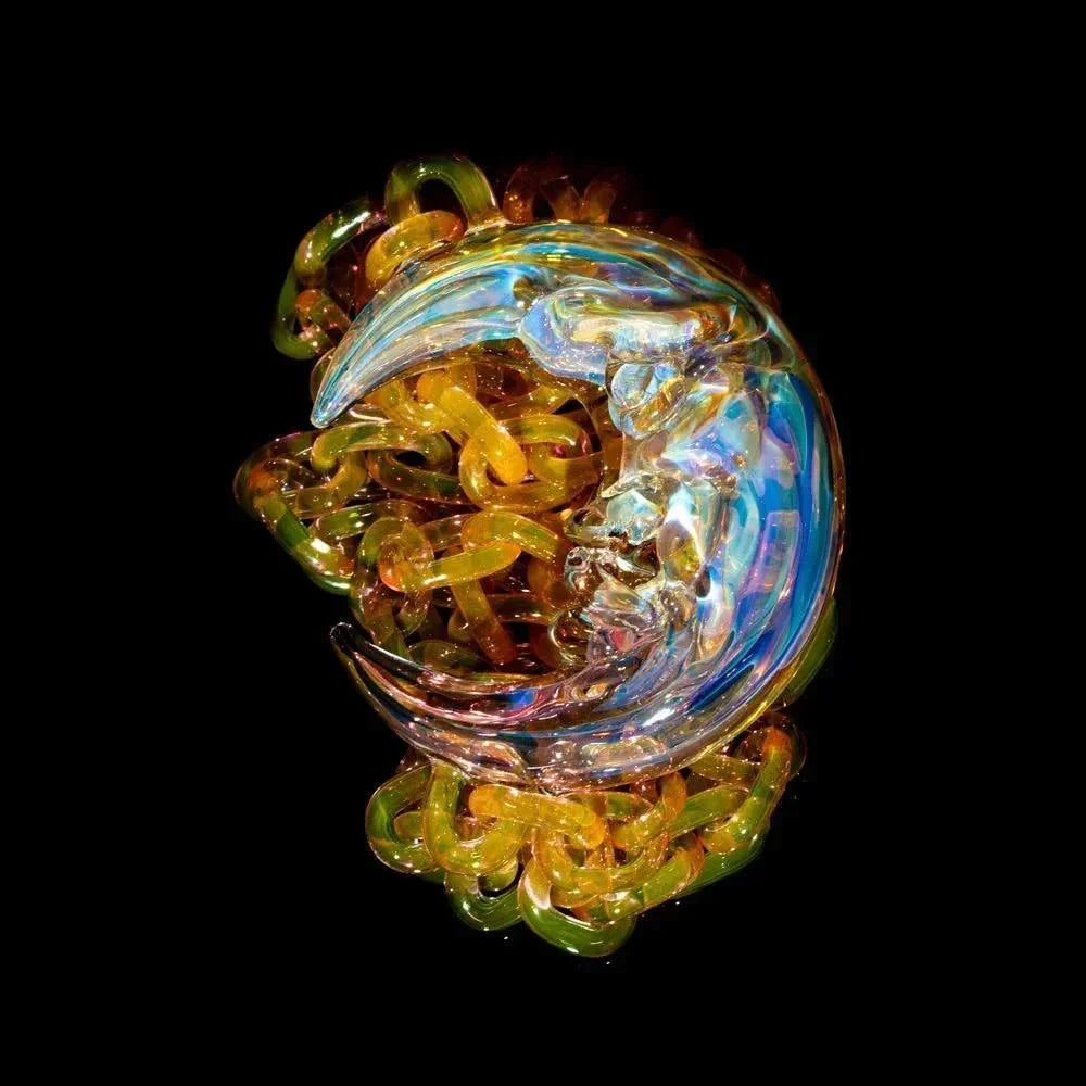Heady glass art crescent moon sculpture with colorful glass chain links on black background