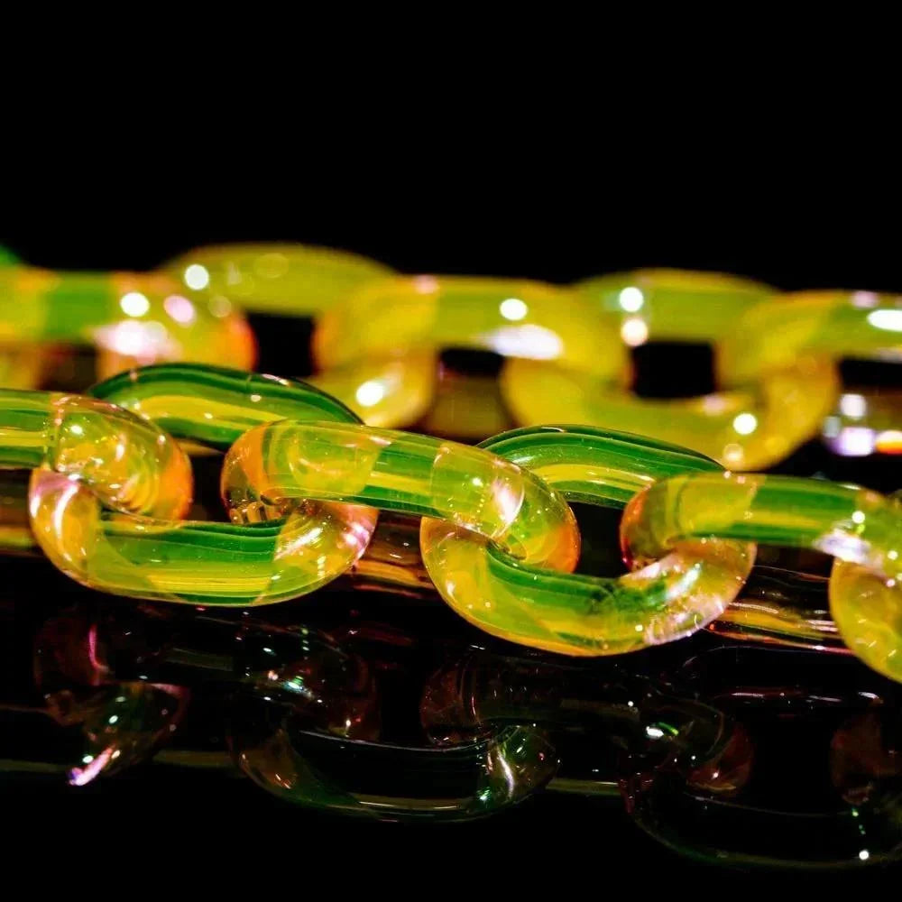 Handmade yellow and green glass chain with iridescent finish on black background