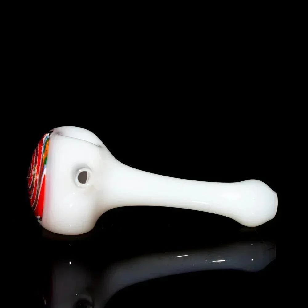 White glass hand pipe with orange, blue, and red swirled bowl on black background