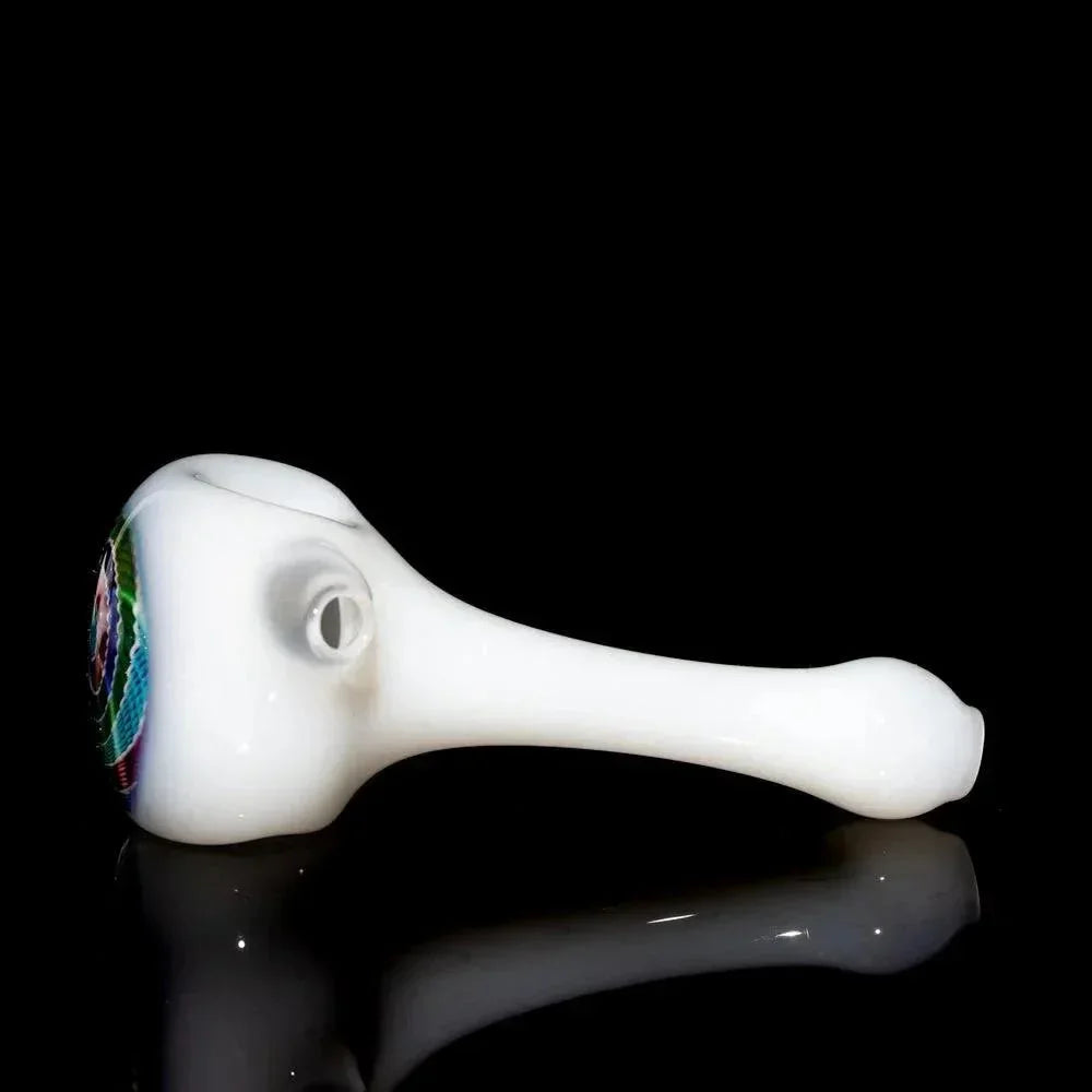 White glass spoon pipe with colorful red, blue, and green retti design on bowl