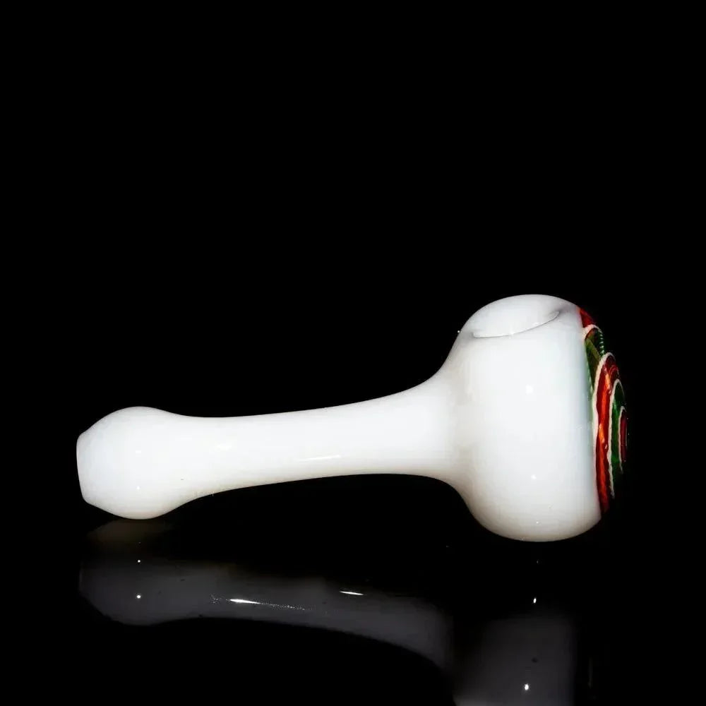 White glass hand pipe with red, orange, and green spiral design on bowl, black background