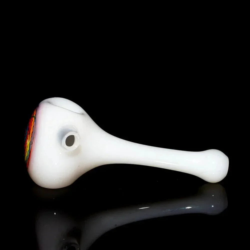 White glass spoon pipe with colorful yellow, orange, and blue retti design on bowl