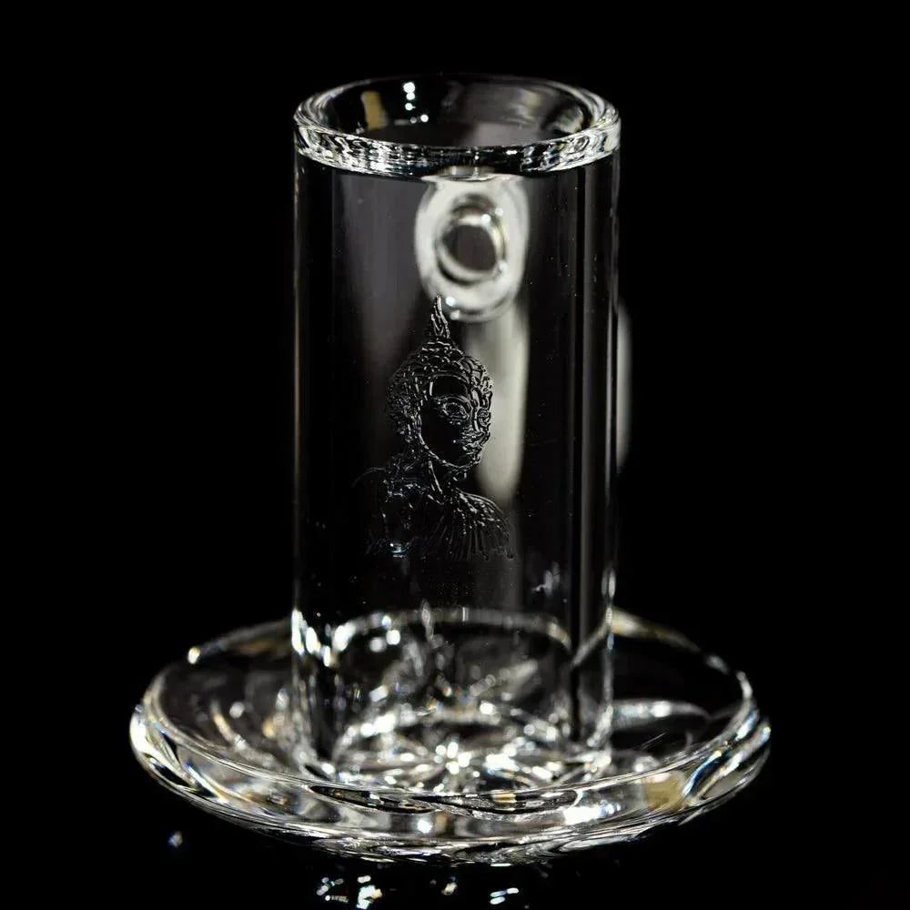 Clear quartz terp blender with etched Buddha design, shown on black background