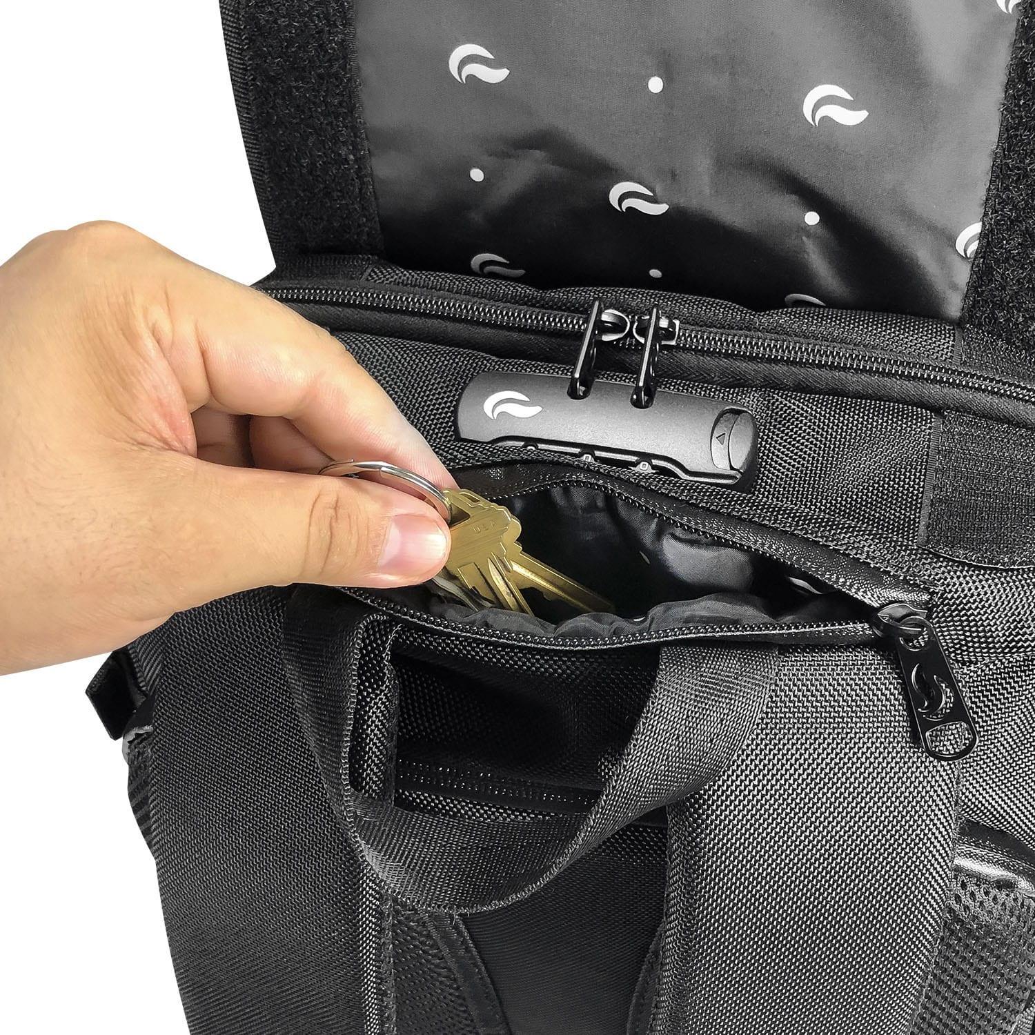 Hand placing keys into zippered top pocket of a black smell proof backpack
