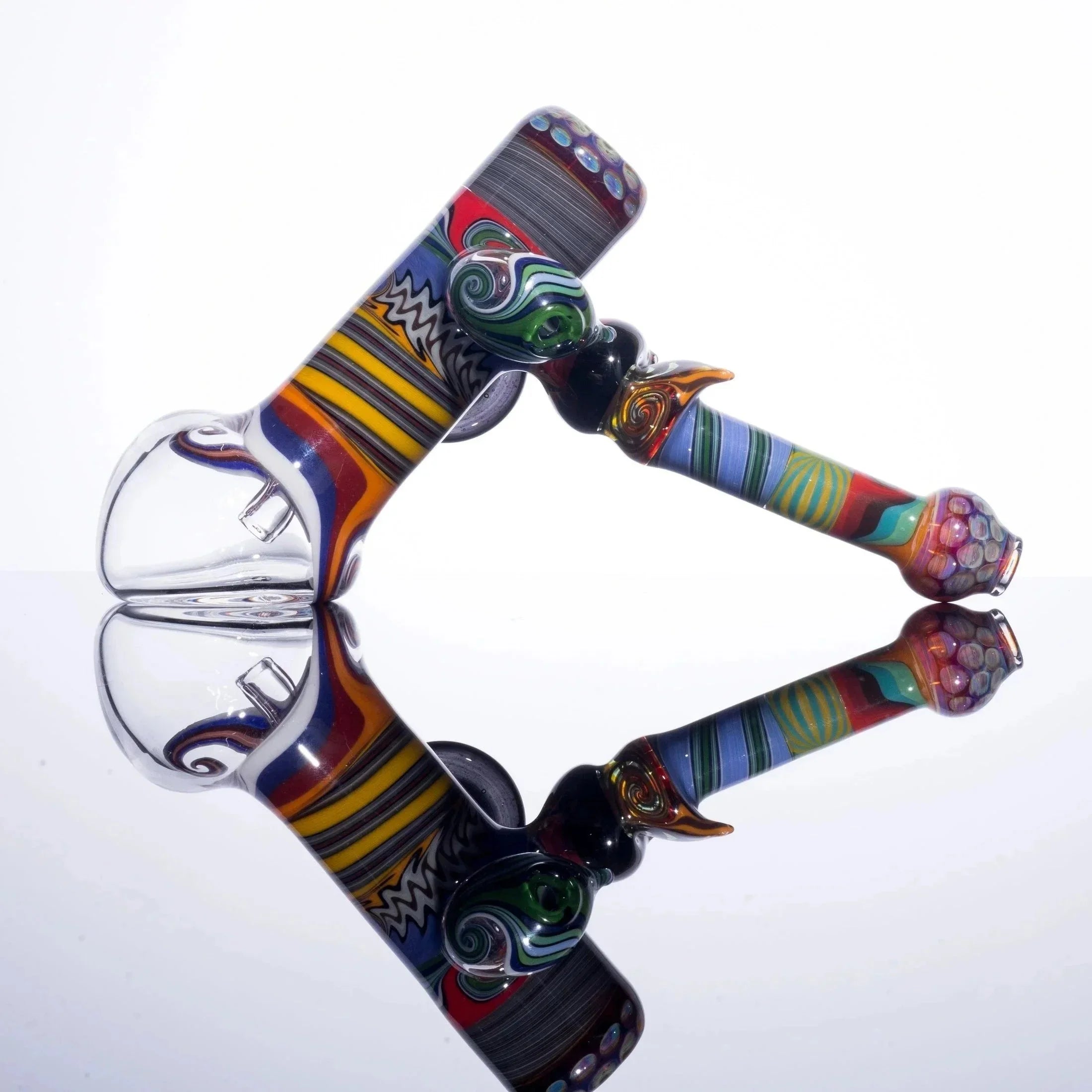Colorful glass bubbler pipe with intricate patterns and reflective surface