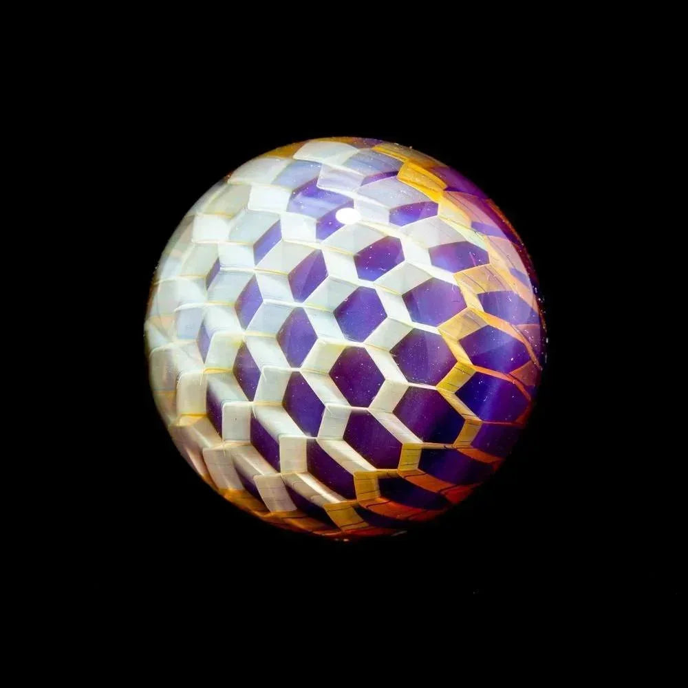 Heady glass marble with geometric cube pattern in purple, yellow, and white on black background
