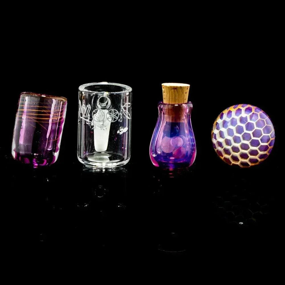 Colorful heady glass dab accessories set with honeycomb carb cap on black background