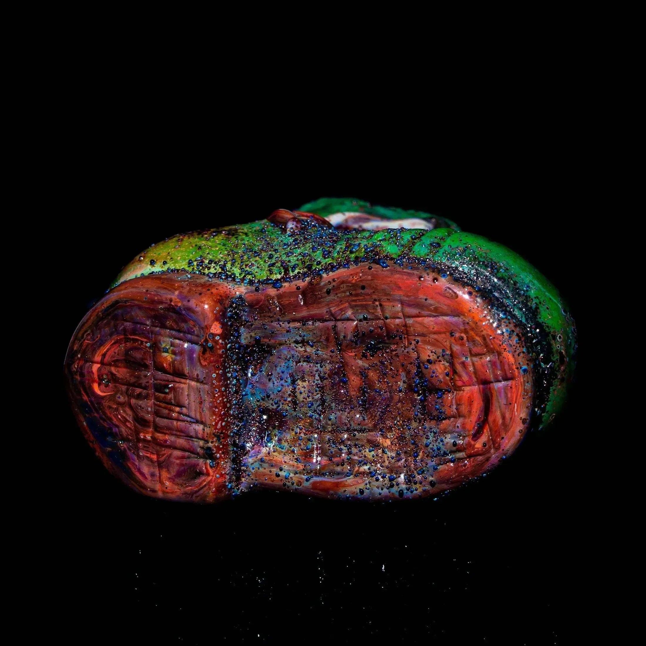 Colorful glass dry pipe with red, green, and blue accents on a black background