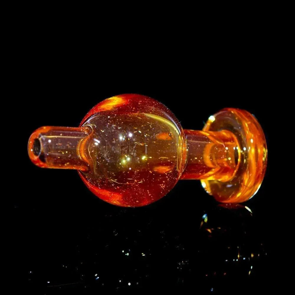 Orange glass bubble cap carb cap for dab rig, displayed on black background